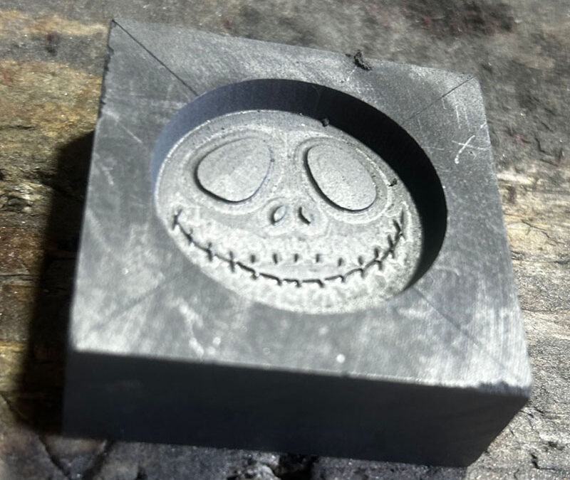 How does the thermal conductivity of graphite affect how your metal cools compared to a material like sand?